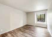Thumbnail 16 of 40 - an empty room with wood floors and a window