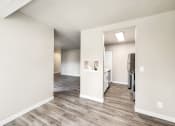 Thumbnail 20 of 40 - a renovated living room and kitchen with white walls and wood flooring