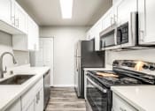 Thumbnail 13 of 40 - the preserve at ballantyne commons apartment kitchen with stainless steel appliances