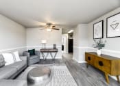 Thumbnail 8 of 15 - a living room with gray couches and a coffee table