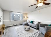 Thumbnail 9 of 15 - a living room with a ceiling fan and a large window