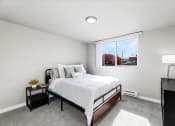 Thumbnail 13 of 15 - a bedroom with a bed and a large window