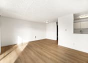 Thumbnail 26 of 49 - A room with wooden floors and white walls.
