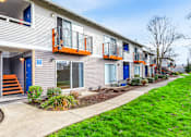 Thumbnail 1 of 49 - A row of townhouses with blue doors and windows.