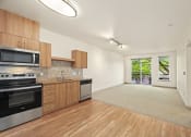Thumbnail 10 of 20 - a kitchen with wooden cabinets and appliances and a door to a living room