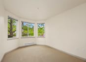 Thumbnail 6 of 20 - a living room with three windows and a carpet