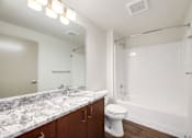 Thumbnail 16 of 38 - a bathroom with a shower toilet and sink and a mirror