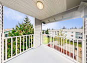 Thumbnail 28 of 34 - a balcony with white railings and a view of a yard and a house