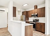 Thumbnail 4 of 32 - A modern kitchen with wooden cabinets and stainless steel appliances.