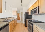 Thumbnail 17 of 42 - a kitchen with stainless steel appliances and wooden cabinets