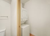 Thumbnail 37 of 42 - a laundry room with a washer and dryer and a door to the closet