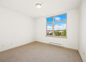 Thumbnail 26 of 42 - an empty room with a window and a carpet