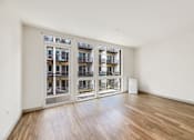 Thumbnail 10 of 38 - a living room with a large window and a wood floor