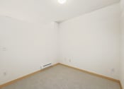 Thumbnail 34 of 42 - a room with a carpeted floor and a white wall