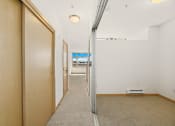 Thumbnail 28 of 42 - a hallway with a sliding glass door and a carpeted floor
