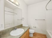 Thumbnail 30 of 42 - a bathroom with a sink toilet and shower and a mirror