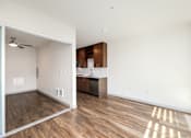 Thumbnail 15 of 38 - an empty living room and kitchen in a new home