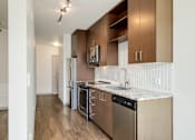 Thumbnail 13 of 38 - a kitchen with stainless steel appliances and a marble counter top