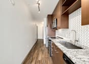 Thumbnail 14 of 38 - a kitchen with marble counter tops and wooden cabinets and a sink