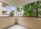 Thumbnail 16 of 29 - a covered porch with a view of trees and apartment buildings
