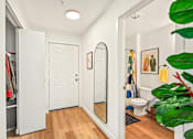 Thumbnail 33 of 34 - a white bathroom with a mirror and a closet