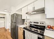 Thumbnail 26 of 34 - a kitchen with stainless steel appliances and white cabinets