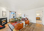 Thumbnail 21 of 34 - a living room with a fireplace and leather furniture