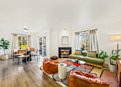 Thumbnail 20 of 34 - a living room with a couch and a fireplace