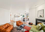 Thumbnail 22 of 34 - a living room with leather furniture and a fireplace