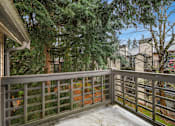 Thumbnail 11 of 16 - A balcony with a railing and snow on the ground.