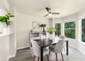 Thumbnail 5 of 20 - a dining room with a table and chairs