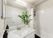 Thumbnail 9 of 20 - a bathroom with a sink and a mirror
