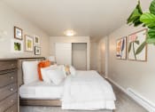 Thumbnail 7 of 20 - a bedroom with white bedding and colorful pillows