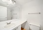 Thumbnail 45 of 49 - A white bathroom with a sink, toilet and bathtub.