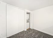 Thumbnail 46 of 49 - A white closet with a door and a shelf.