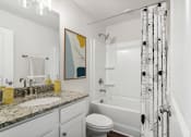 Thumbnail 22 of 31 - a bathroom with a shower and a sink and a toilet
