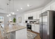 Thumbnail 5 of 31 - a kitchen with stainless steel appliances and a granite counter top
