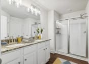 Thumbnail 18 of 31 - a white bathroom with a shower and a sink