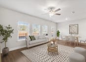 Thumbnail 12 of 31 - a living room with a couch and a ceiling fan