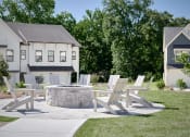 Thumbnail 16 of 48 - a patio with chairs and a fire pit