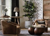 Thumbnail 7 of 48 - a living room with two brown chairs and a glass coffee table