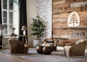 Thumbnail 6 of 48 - a living room with two chairs and a table and the bend logo on the wall