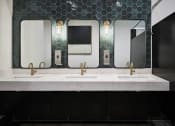 Thumbnail 13 of 48 - a bathroom with three sinks and three mirrors