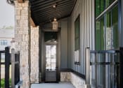Thumbnail 3 of 48 - the front porch of a building with a black ceiling and a door