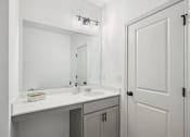 Thumbnail 44 of 48 - a white bathroom with a sink and a mirror