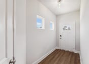 Thumbnail 3 of 31 - a bedroom with white walls and a white door