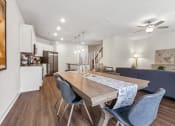 Thumbnail 10 of 31 - a dining room with a wooden table and blue chairs