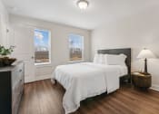 Thumbnail 23 of 31 - a bedroom with a bed and two windows