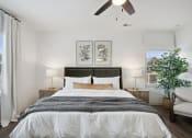 Thumbnail 36 of 48 - a bedroom with a bed and a ceiling fan