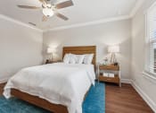 Thumbnail 17 of 31 - a bedroom with a large bed and a ceiling fan